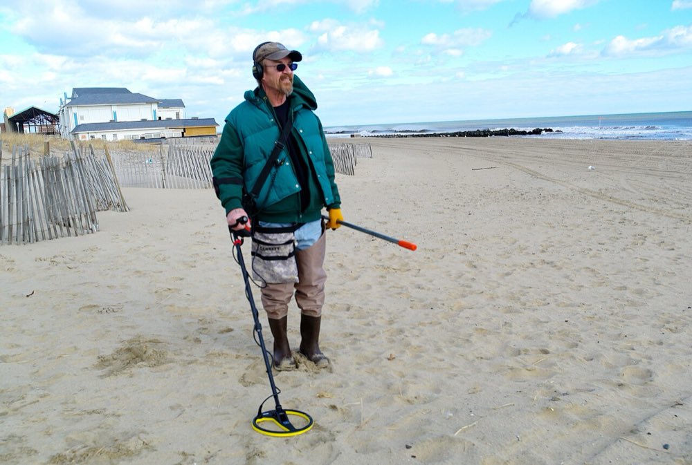 Metal detecting on a sandy beach