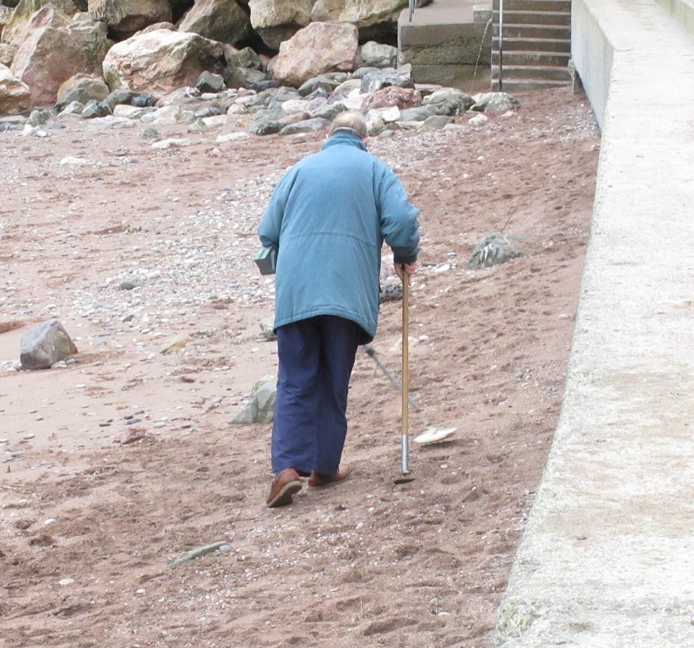 A detectorist on Oddicombe beach, Devon