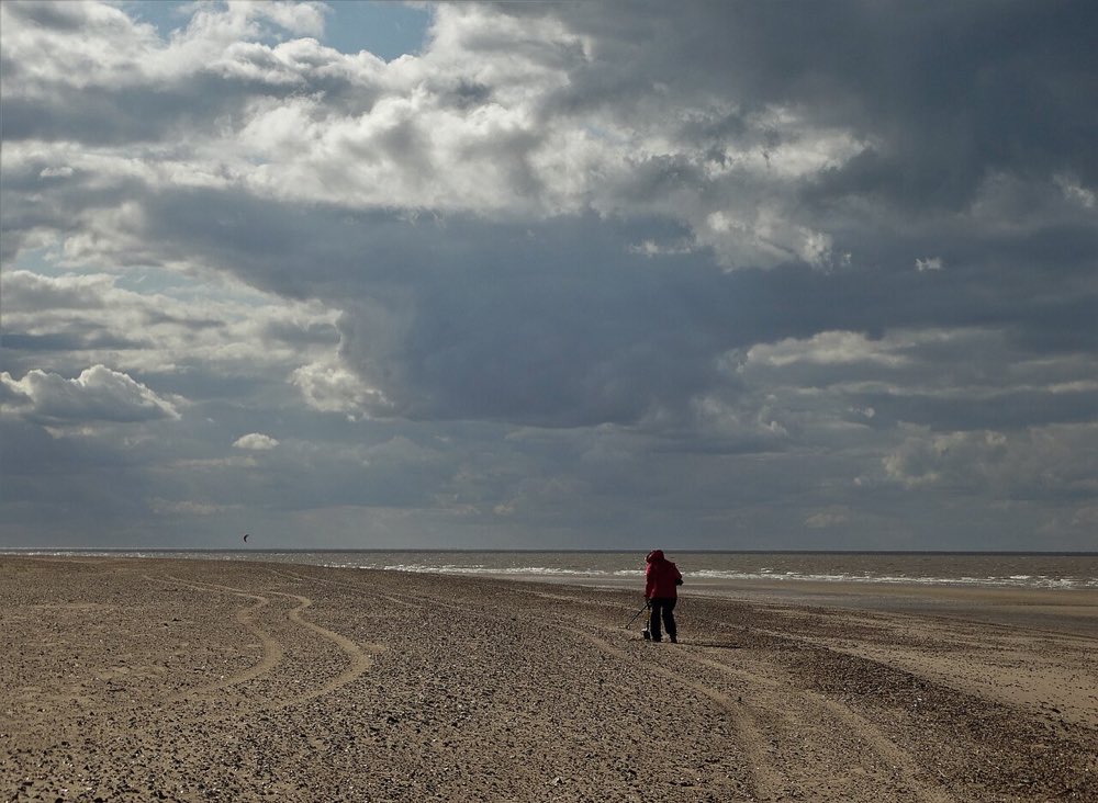 A detectorist on the beach