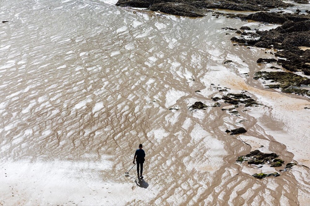 A detectorist on the beach at Saint-Malo